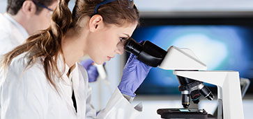 picture of researcher looking in microscope