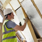 General construction worker installing insulation
