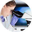 researcher looking in microscope