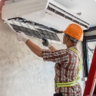 Construction worker installing an air system