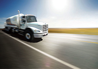 An Airgas truck drives down a road.