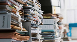 Stacks of binders stuffed with paperwork.