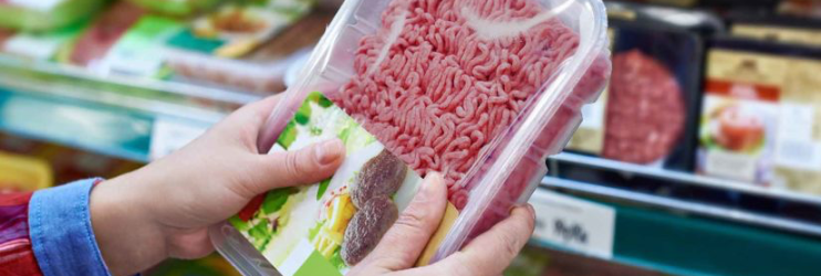 Close-up of packaged ground beef kept fresh with Modified Atmosphere Packaging in the hands of a supermarket customer.