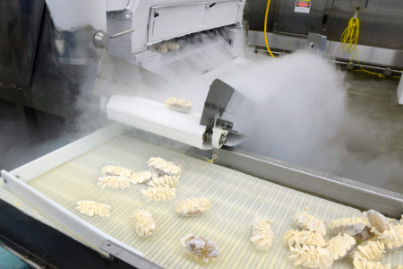 Frozen twice-baked potatoes on a food-freezing production line.