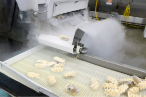 Frozen twice-baked potatoes on a food-freezing production line.