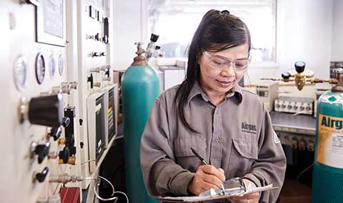 An Airgas Total Managed Services technician studies a form while working on a customer site.