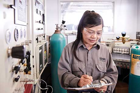 An Airgas Total Managed Services technician studies a form while working on a customer site.