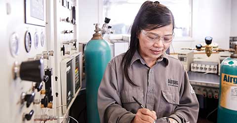 An Airgas Total Managed Services technician studies a form while working on a customer site.