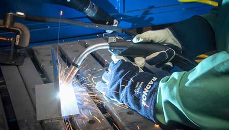 Welder, welding the inside of a giant pipe