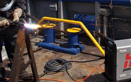 A Hypertherm user gouges a welding workpiece with a Powermax power system.