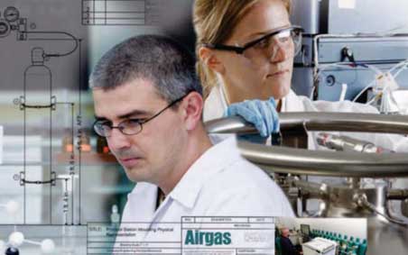 Two people in white coats working in lab around gas cycliners.