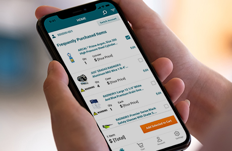 Close up of a woman’s hands holding a smartphone with the teal Airgas Reorder App Welcome Screen on it.