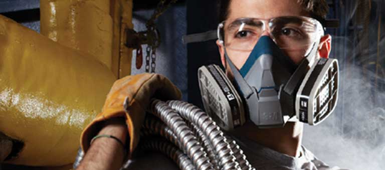 A worker in a dusty environment wearing a 3M Respirator