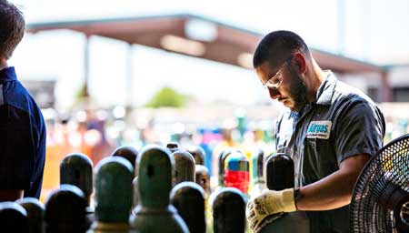 An Airgas worker maintaining and preparing gas cylinders.