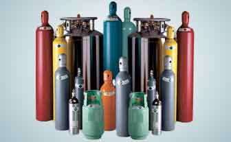 An Airgas worker maintaining and preparing gas cylinders.