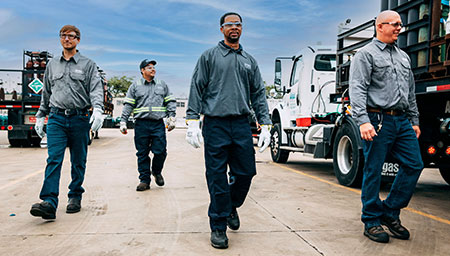 Four Airgas associates walking toward the camera