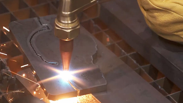 A automated plasma cutting table cutting a steel plate being cut with a Victor tourch