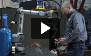 A welding technicion programming a BotX cobot