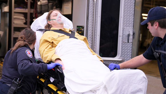 An Airgas employee moving an oxygen liquid cylinder