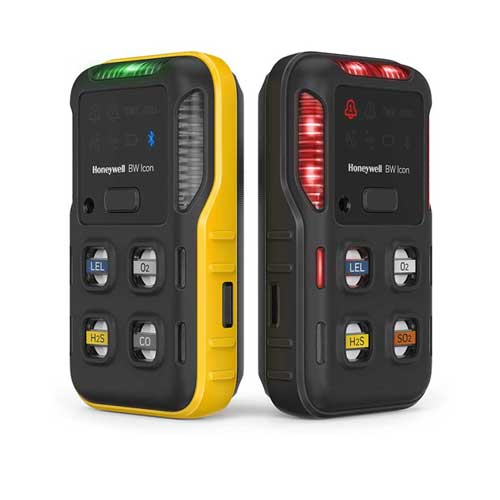 Two Honeywell BW™ Portable Multi-Gas Detectors the yellow shows a safe reading, the black shows a warning lights