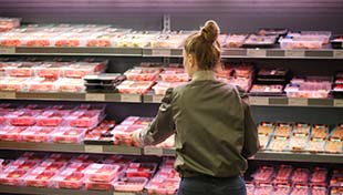 A woman shopping for meat in a supermarket