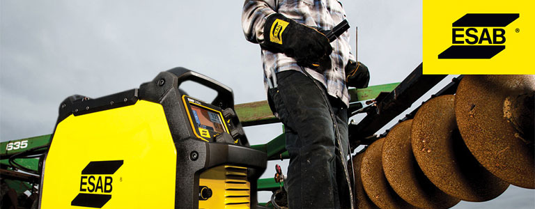 Man uses ESAB welding machine to perform maintenance, repair and operations (MRO) application on a tractor plough in a farm field.
