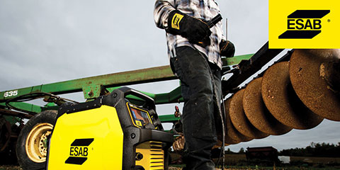 Man uses ESAB welding machine to perform maintenance, repair and operations (MRO) application on a tractor plough in a farm field.