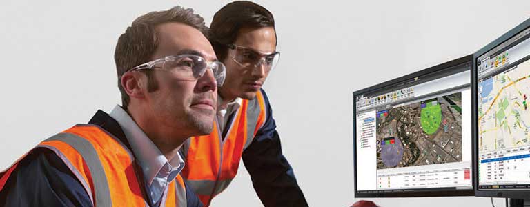 Two workers wearing Honeywell Uvex safety glasses.