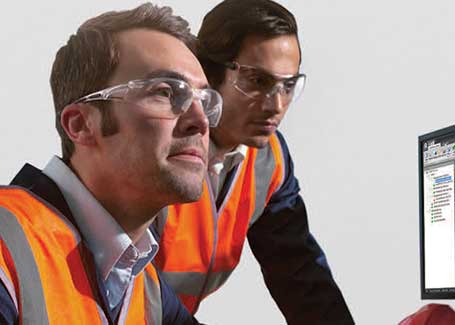 Two workers wearing Honeywell Uvex safety glasses.