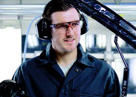 An automobile manufacturer wearing Honeywell earmuffs