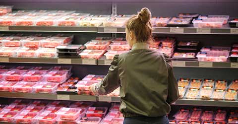 Shopper selecting packaged meat at supermarket; with title in upper left corner: Modified Atmosphere Packaging (MAP).